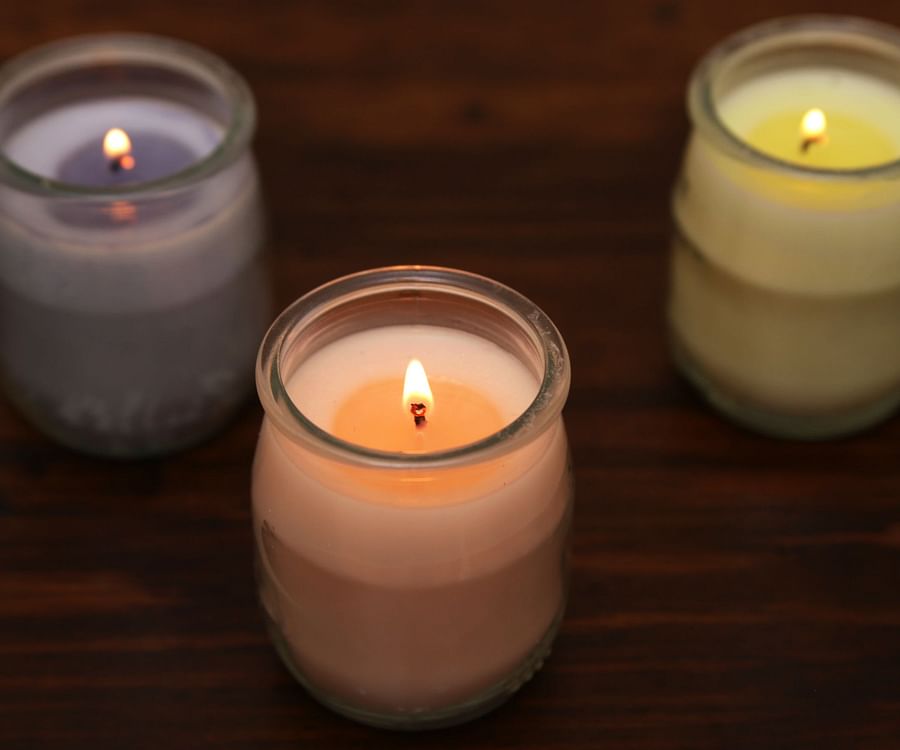 assorted homemade candles with different waxes