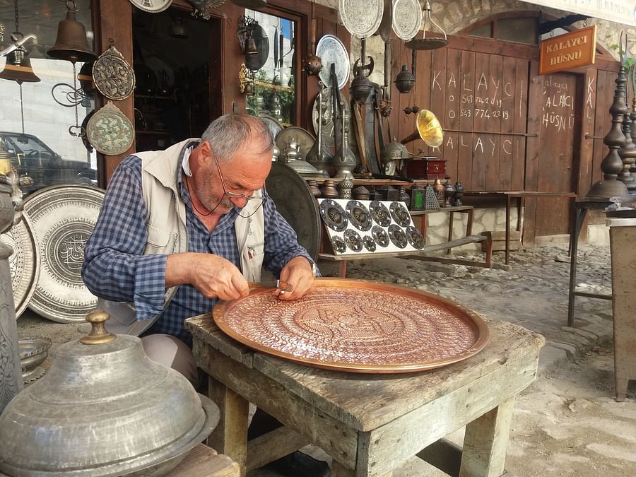 Person carefully crafting a homemade candle