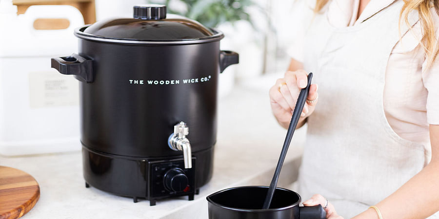Person using wax melter with safety gear
